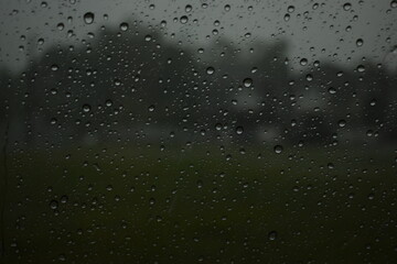 water drop on mirror in rainy day, blur natural background