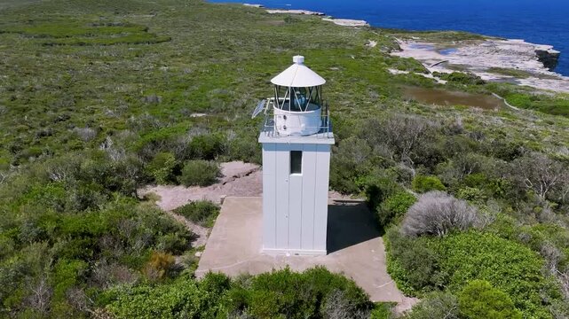 Kurnell, Sydney, Australia: Drone Video: Flying in a circle around Cape Baily Lighthouse -view from above of the beautiful landscape and sandstone coastline of Kamay National Park in New South Wales.