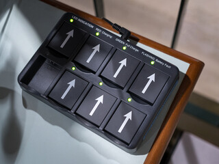Headset battery charging case, charging in process. Top view.