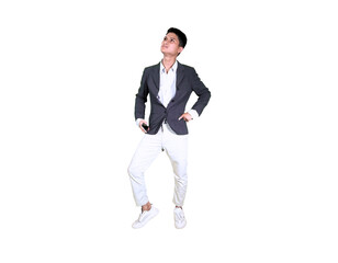 A young man in casual attire is captured mid-air in a squatting pose, looking down at his hands...