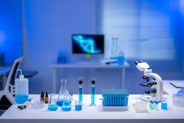 Laboratory equipment displaying beakers, test tubes, and microscope in research lab