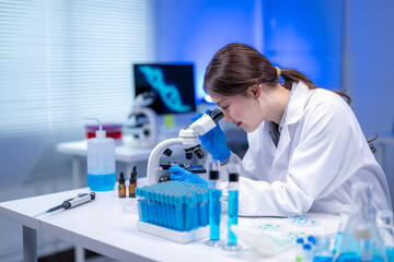 Scientist using microscope analyzing samples in laboratory for scientific research