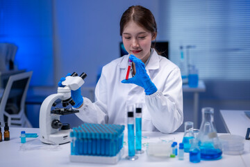 Scientist analyzing blood sample using microscope in laboratory