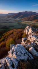 Golden Hour Scenery of Vibrant Fall Colors Over Mountain Range with Rocky Foreground