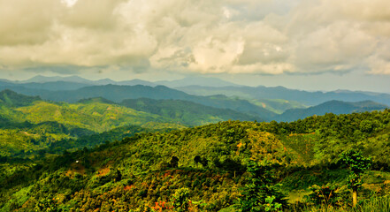 beautiful view of green mountain landscape with white clouds in the background