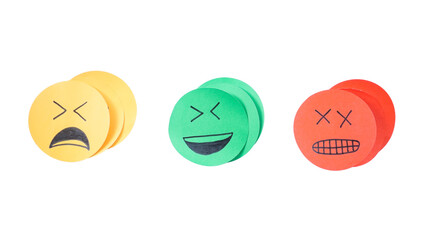 Pile of yellow sad face, green happy face, red angry face paper cutout emoji isolated on...