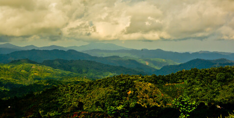 beautiful view of green mountain landscape with white clouds in the background
