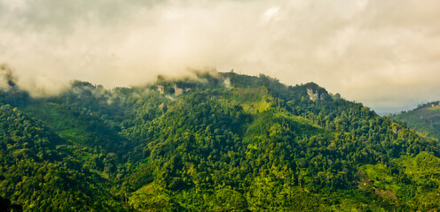 beautiful view of green mountain landscape with white clouds in the background