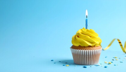 A single cupcake rests on a pale blue plane&mdash;its yellow frosting crowned by one striped candle, a miniature monument to intention. This is not a party&mdash;it&rsquo;s the memory of a wish.