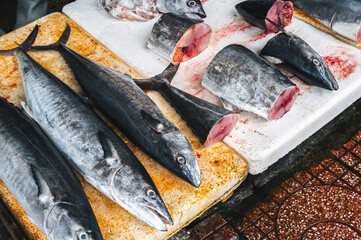 catch of fresh mackerel fish. Chilled whole and cut king mackerel on the counter at the Asian...