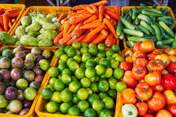 assortment of fresh vegetables on the counter at grocery farmers market in Asia