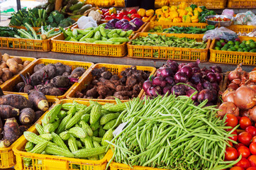 assortment of fresh vegetables on the counter at street grocery farmers market