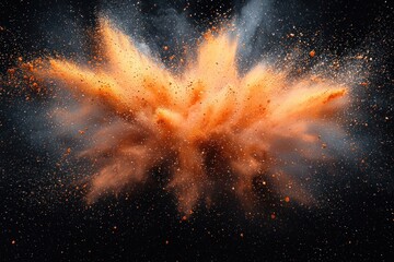 Abstract explosion of orange and brown powder on black background