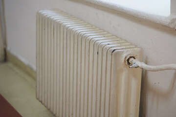 Old radiator in home interior during winter season