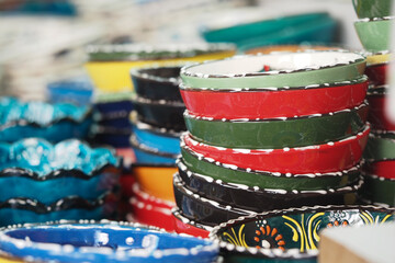 Colorful handmade bowls stacked in a market setting