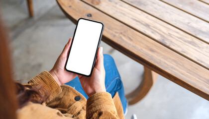 Woman using phone with cafe mockup.