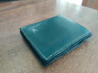 black leather wallet with white stitching pattern