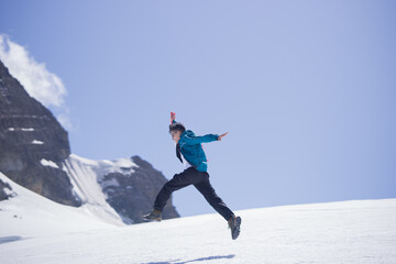 Man jumping high on snowy mountain in Peru