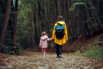 Mother and Daughter Walking Hand in hand on a Forest hike. Family bonding and spending time in...
