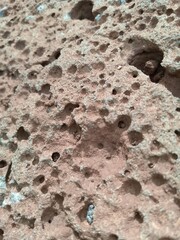 Close-up of the rock with many holes seen where the car came from the mountain.