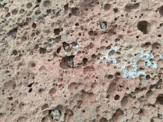 stone wall texture There are many holes in the rocks that fell from the mountain. The distant view of the rocks has many holes.