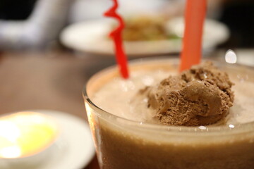 Decadent Chocolate Milkshake with Scoop of Ice Cream in Glass – Close-Up of Creamy Frozen Dessert Drink with Straws, Perfect for Summer, Cafes, and Sweet Treat Concepts