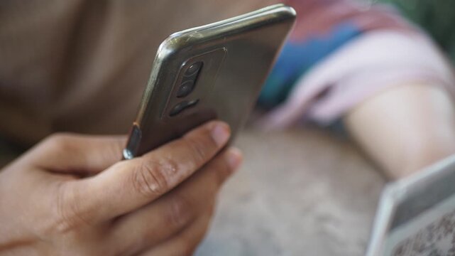 smart phone in woman hand scanning QR code for menu 