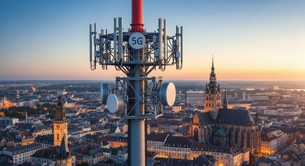 5G Antenna Tower Over Cityscape at Sunset Aerial View