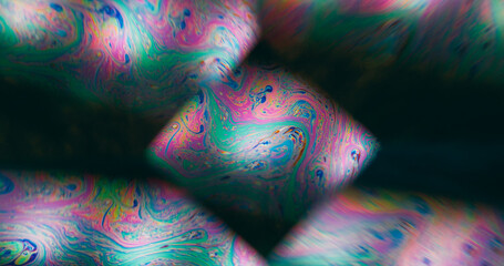 Holographic defocused liquid. Geometric flare. Colorful ink gasoline diamond lens swirl black background. Purple green rainbow stream.