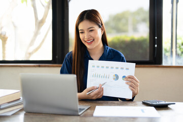 Young Asian businesswoman work at home and virtual video conference meeting with colleagues...