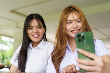 Young Thai University Students Relaxing Together at Campus Cafe Outdoors Taking Selfie Photo