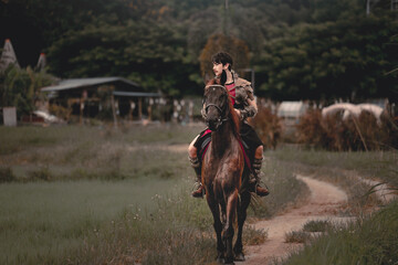 Young Rider on Horseback in Scenic Rural Landscape Surrounded by Nature
