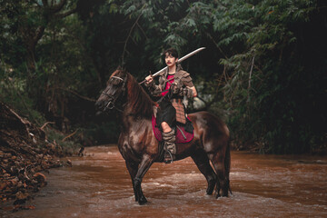Warrior on Horseback in Forest Stream with Sword Ready for Battle