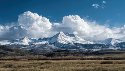 Fototapeta premium Snowy mountain range under dramatic sky