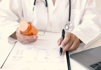 Female doctor reviews test results and diagnoses disease, records, prescribes medicine, and...