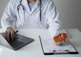 Female doctor reviews test results and diagnoses disease, records, prescribes medicine, and provides explanations. Recommend the use of medication Medical and wellness concept