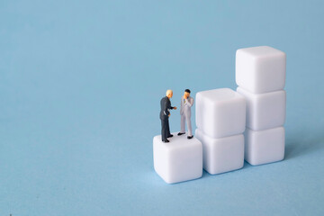 miniature people discussing business growth. block growth chart concept