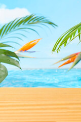 Summer poolside scene with wooden deck, tropical bird of paradise flowers, and green palm leaves against bright blue water and sky. Perfect background for cosmetics or product display.