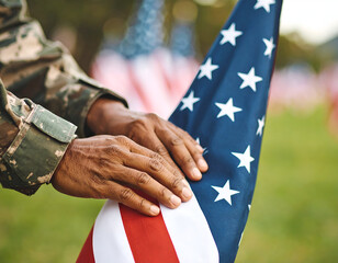 Soldier folds US flag outdoors.