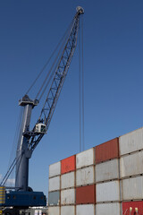 Port Crane and Stacked Shipping Containers Global Logistics and Trade
