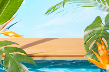 Poolside scene with wooden deck, tropical green leaves and bird of paradise flowers under clear...
