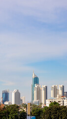 Obraz premium A high resolution image of modern skyscrapers and office towers in Jakarta central business district, Indonesia. The photo showcases glass covered buildings under a dramatic cloudy sky, representing t