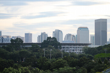 Fototapeta premium A high resolution image of modern skyscrapers and office towers in Jakarta central business district, Indonesia. The photo showcases glass covered buildings under a dramatic cloudy sky, representing t
