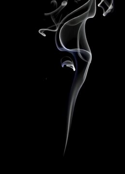 Graceful white smoke flowing against a black background in a vertical video format, ideal for abstract effects, transitions, or content related to cigarette smoke