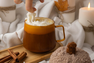 Seasonal drink cacao coffee with whipped cream and cinnamon sticks Thanksgiving and Hello Fall...