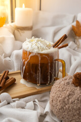 Pumpkin spiced latte morning warming coffee. Fall Drinks for Halloween Thanksgiving Holiday beverage Autumn spicy cinnamon flavor seasonal hot drinking in cozy orange cup. Atmosphere of cold rainy