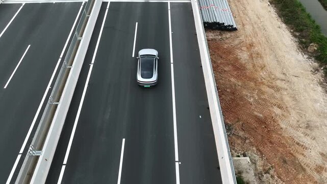 Car driving on highway near Guangzhou Yangjiang surrounded by nature during the day