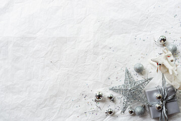 Set of silver Christmas decorations on paper texture background, silver decorative present, silver...