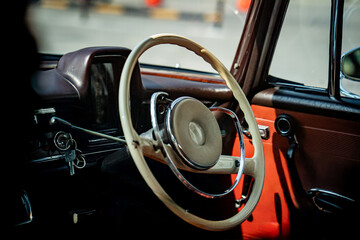 Vintage Classic car steering wheel, with chrome and leather textures in sharp detail, showcases the...