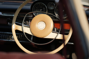 Vintage Classic car steering wheel, with chrome and leather textures in sharp detail, showcases the...